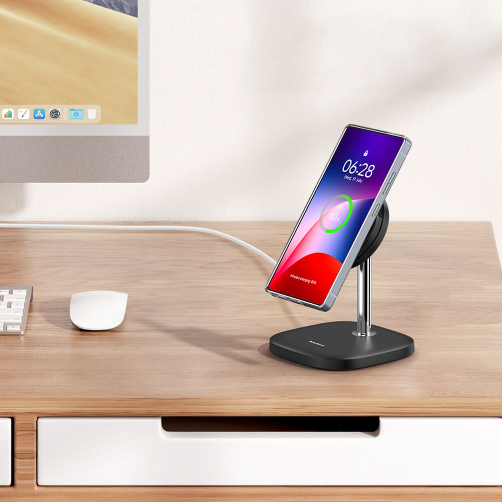 Samsung phone on a charging stand with charging cable on a desk