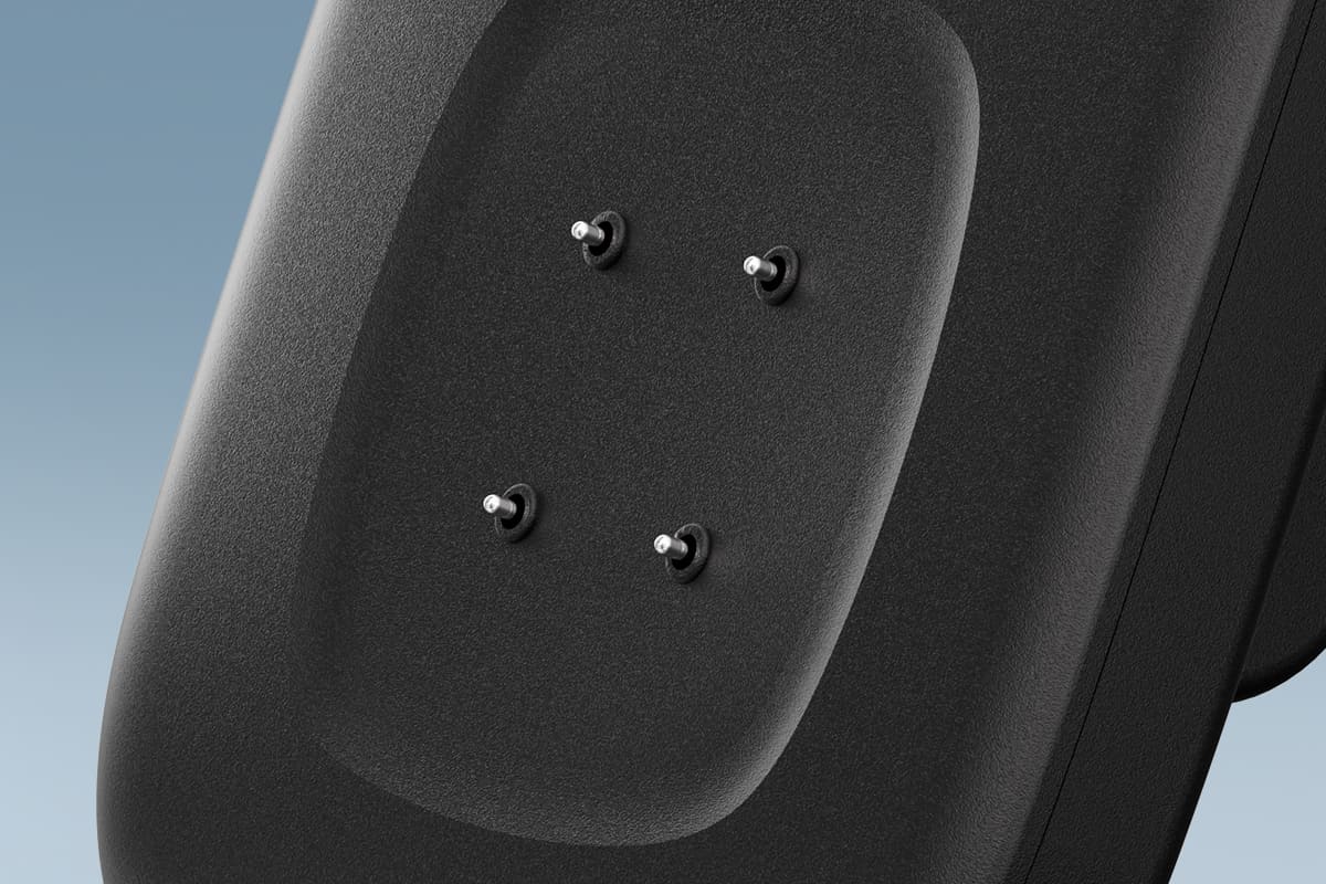 Four metal charging pins on the SwanScout 505FB charging panel for Fitbit smartwatches